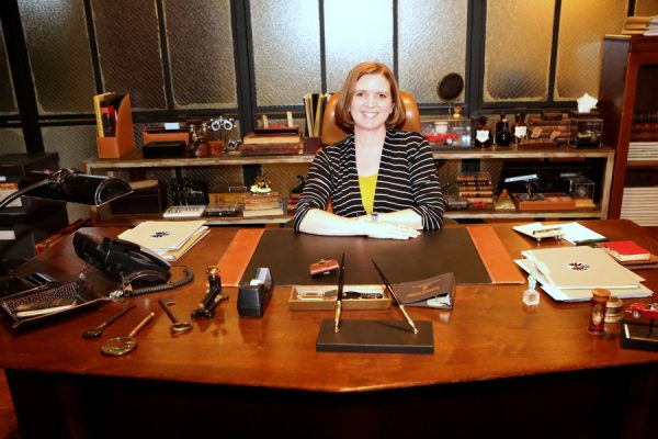 Agent Laura sitting at Coulson's desk on the set of Agents of S.H.I.E.L.D. | photo by ABC/Adam Taylor 